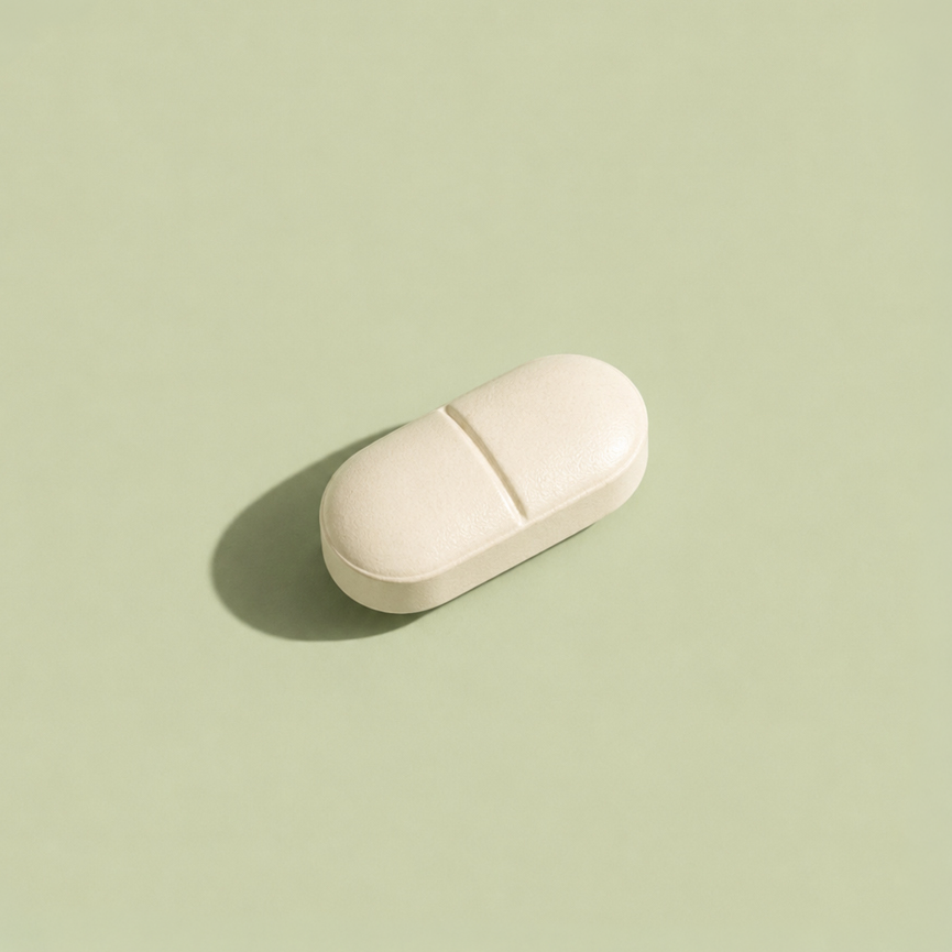 Medication capsules on a warm neutral surface